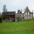Two adjoining stone houses with stone outbuildings.